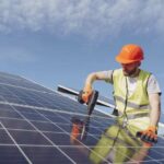 Solar technician installing solar panel