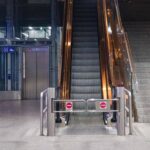 A modern indoor escalator and elevators in a public space, showcasing urban architecture.